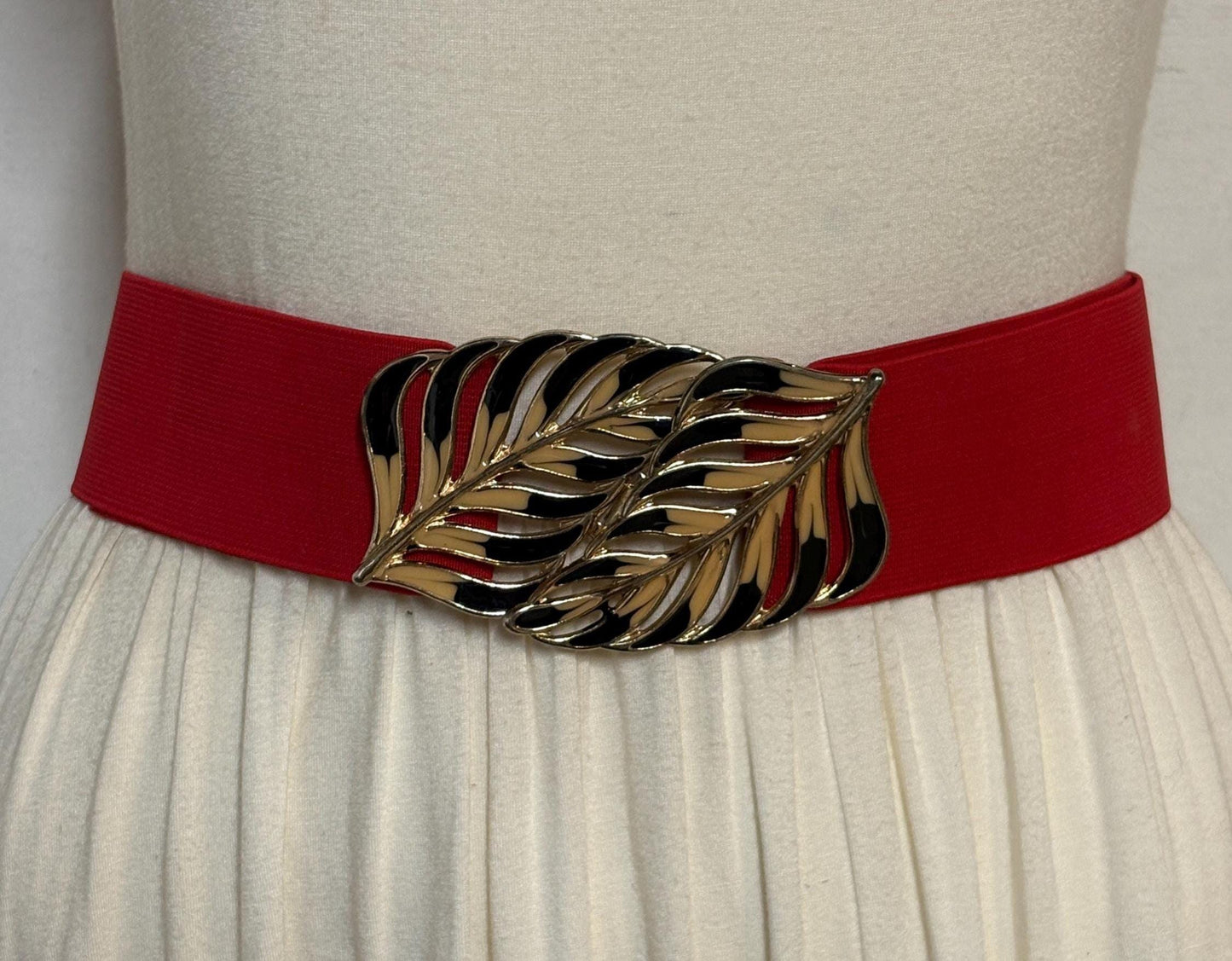 80s vintage womens elastic tall belt. Large exotic palm leaf buckle. Flattering cinch effect. Extensive adjustable size range. Unused NOS