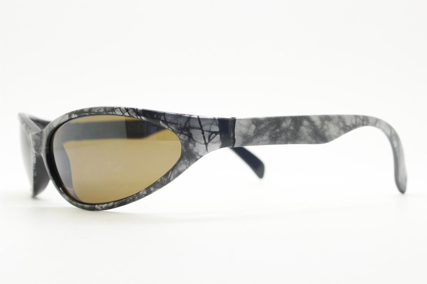 90s vintage sport shield aerodynamic sunglasses. Silver and black marble print wraparound bug eye visor with brown lenses. 2000's. Y2K