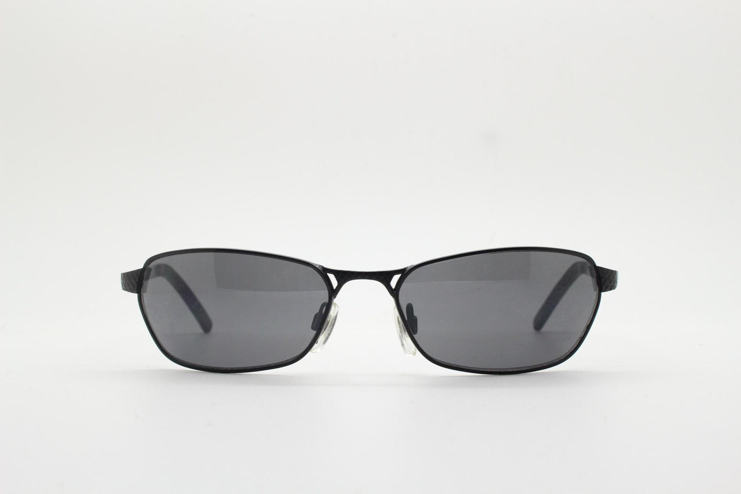 90s vintage wraparound sunglasses. Black satin finish on rectangular frame with unassuming style details. 2000's. Y2K. Unused NOS bug eye