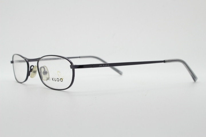 Jai Kudo 90s vintage oval eye glasses. Small low profile optical frames in charcoal grey chrome. Prescription eyeglasses. RX Spectacles