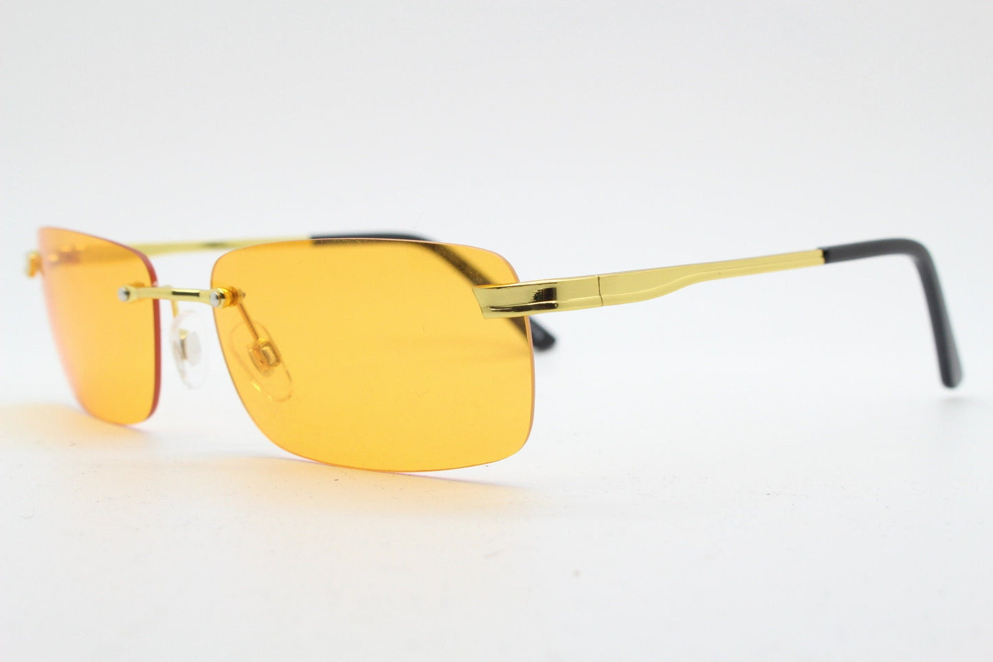 Y2K vintage frameless orange sunglasses. Rectangular lenses with gold bridge and arms. 2000s club kids. 00's. 90s Rave
