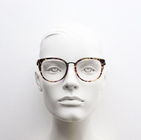 Kenzo vintage round eye glasses made in France. Tortoise with purple tones and matching arm sections. Womens Prescription Optical frames. RX
