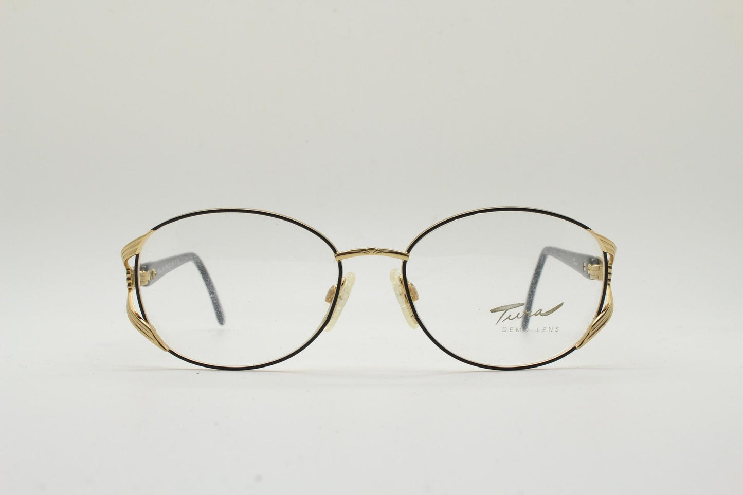 Tura 80s vintage oval eye glasses made in Italy. Womens black and gold optical frame with Y forked temples. Prescription RX. Unused NOS