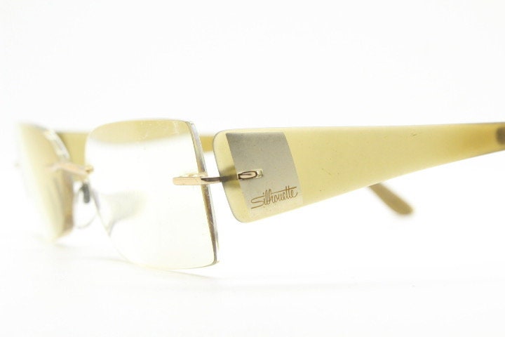 Silhouette rectangular frameless eye glasses model 7599 made in Austria. Minimal optical frame with transparent brown arms. Prescription RX