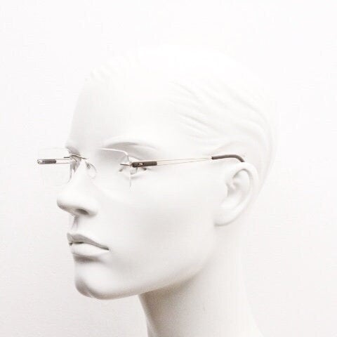 Silhouette rectangular frameless eye glasses model 7677 made in Austria. Minimal lightweight optical frame with golden trim. Prescription RX