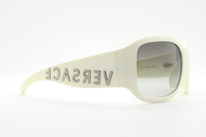Versace Y2k vintage wrap around bug eye sunglasses. Curving white acetate shield frame with huge spell out diamante logo. 2000s. Rhinestone