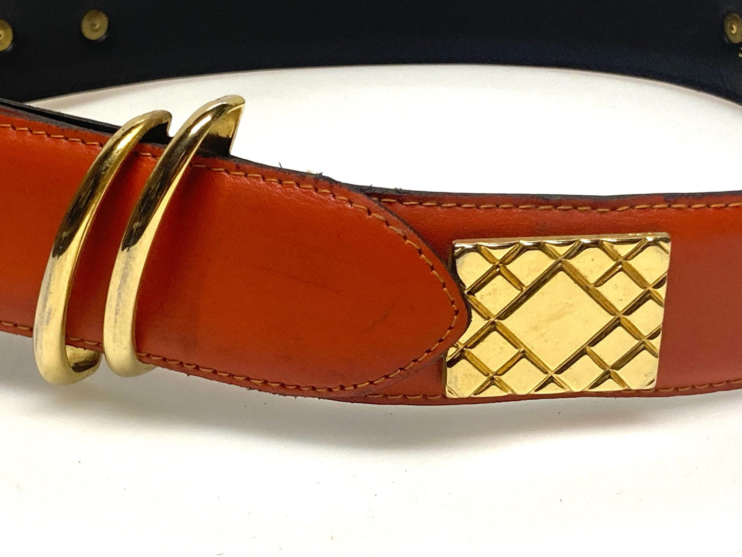 80s vintage womens dress / jeans belt in bright orange leather with golden metal squares. Made in France. Used in good condition