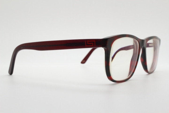 Versace modified wayfarer design eye glasses made in Italy. Mottled brown acetate optical frames with subtle logo. Prescription eyeglasses