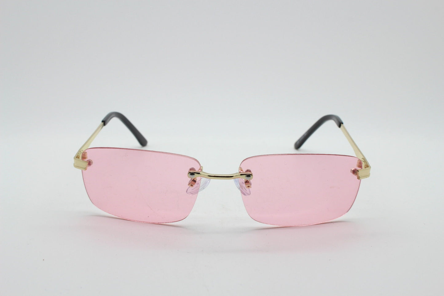 Y2K vintage frameless pink sunglasses. Rectangular lenses with gold bridge and arms. 2000s club kids. 00's. 90s Rave