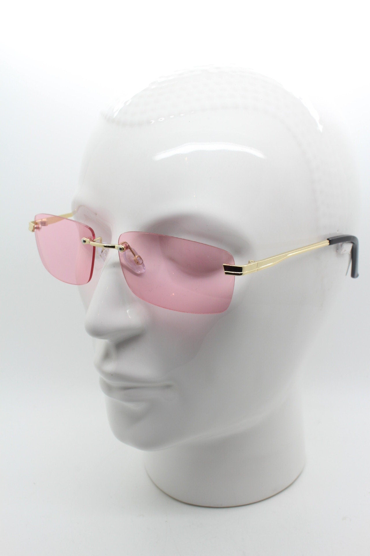 Y2K vintage frameless pink sunglasses. Rectangular lenses with gold bridge and arms. 2000s club kids. 00's. 90s Rave