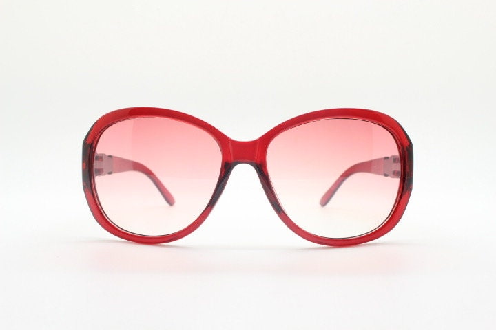 Y2k vintage big bug eye sunglasses. Womens transparent red oversized frame with fabulous pink graduating lenses and metal arm crest. 2000s