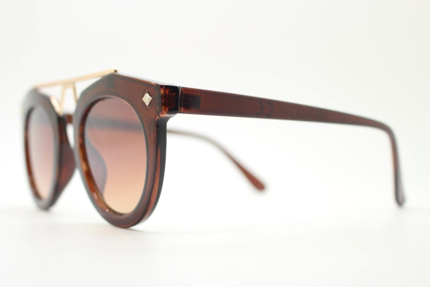Rounded cateye sunglasses with gold 'scaffold' metal bridge. Women's transparent frame with matching brown graduating lenses. Vintage NOS