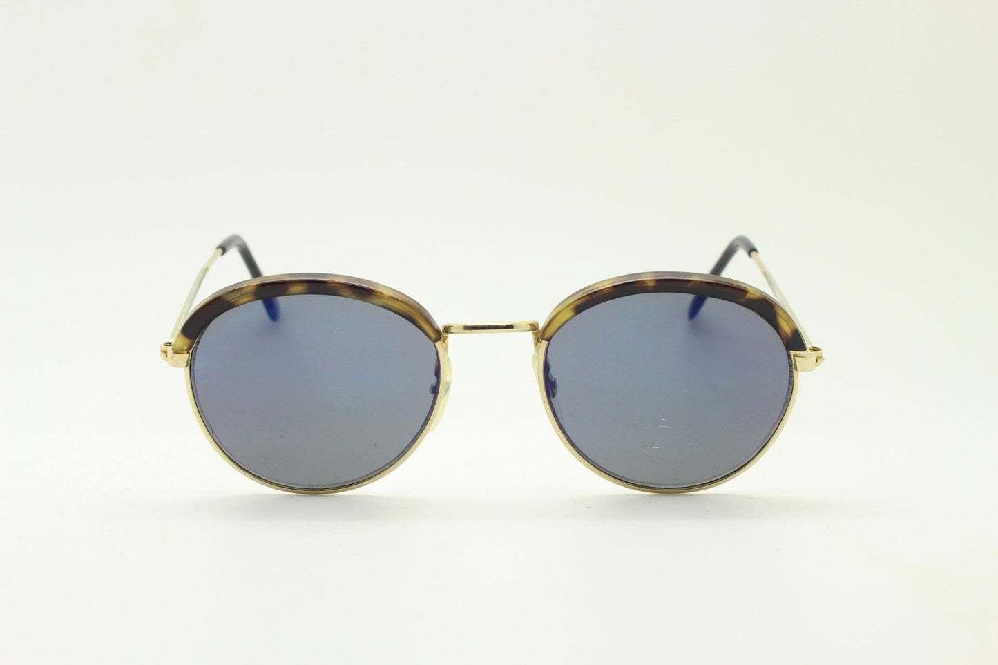 90s round vintage sunglasses. Gold frame with tortoise brows, blue mirror lenses and intricate embossed arm patterns. 1930's style