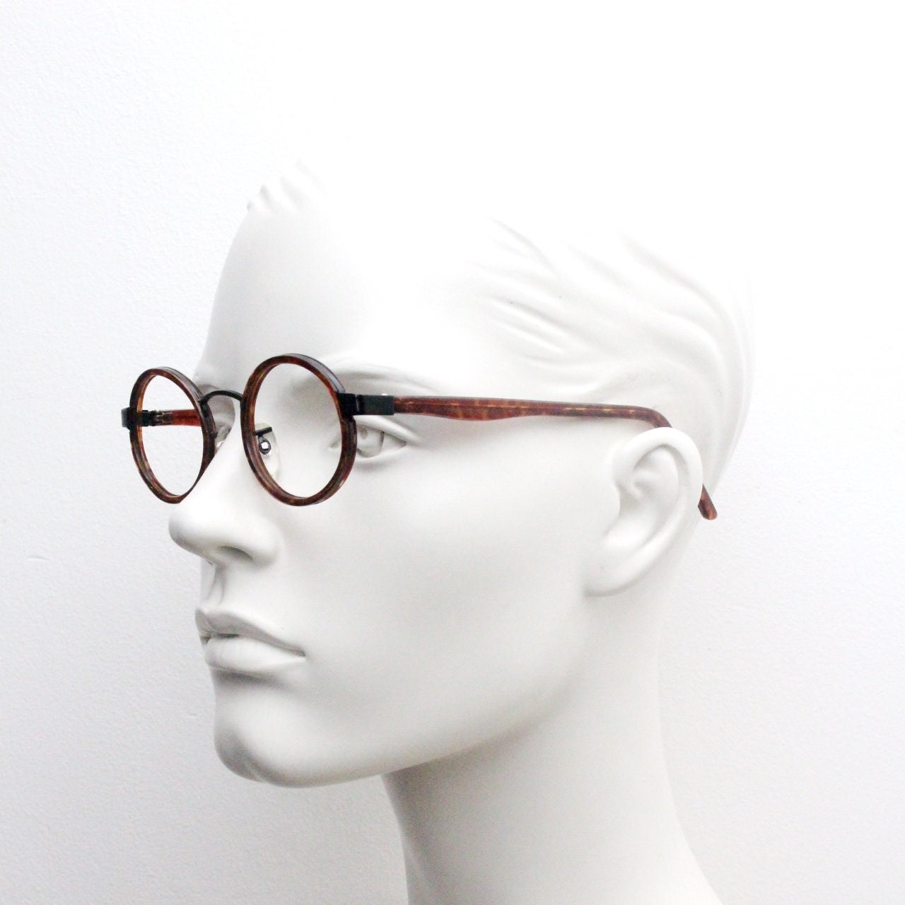90s vintage oval glasses. Minimal slim black optical frame encasing tortoise inserts. 40s, 50s style prescription eyeglasses. RX spectacles