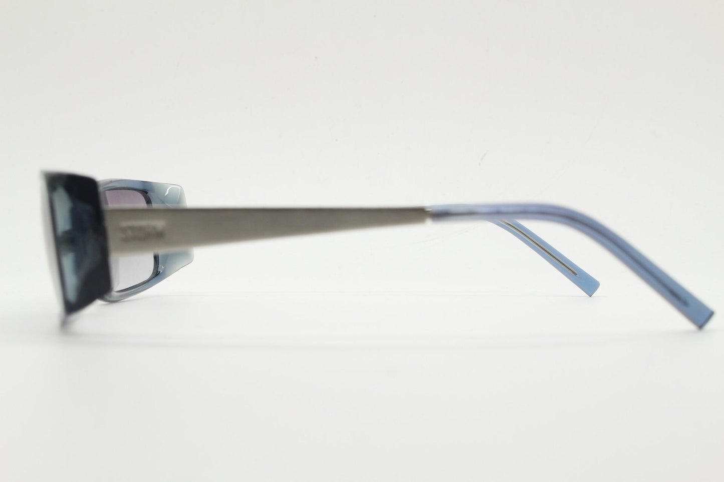 90s vintage rectangular low profile sunglasses by Storm. Transparent grey acetate front with brushed steel arms. NOS. 2000s