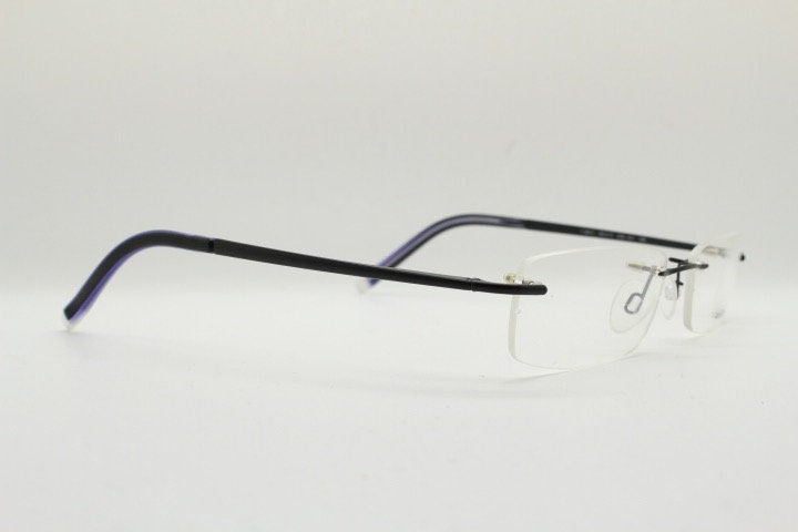 Police 90s vintage rectangular frameless eye glasses made in Italy. Minimal low profile optical frame with black satin metal trim. RX