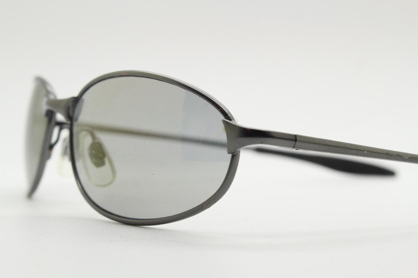90s vintage oval small  bug eye sunglasses. Satin finish frame in gunmetal with straight spear arms. Y2K. 2000s. Unworn NOS