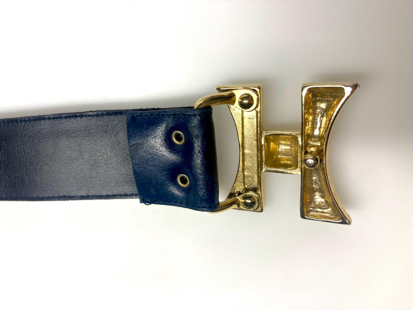 80s vintage womens dress belt in navy blue genuine leather with substantial gold chrome studded 'H' motifs. Made in France. Size S