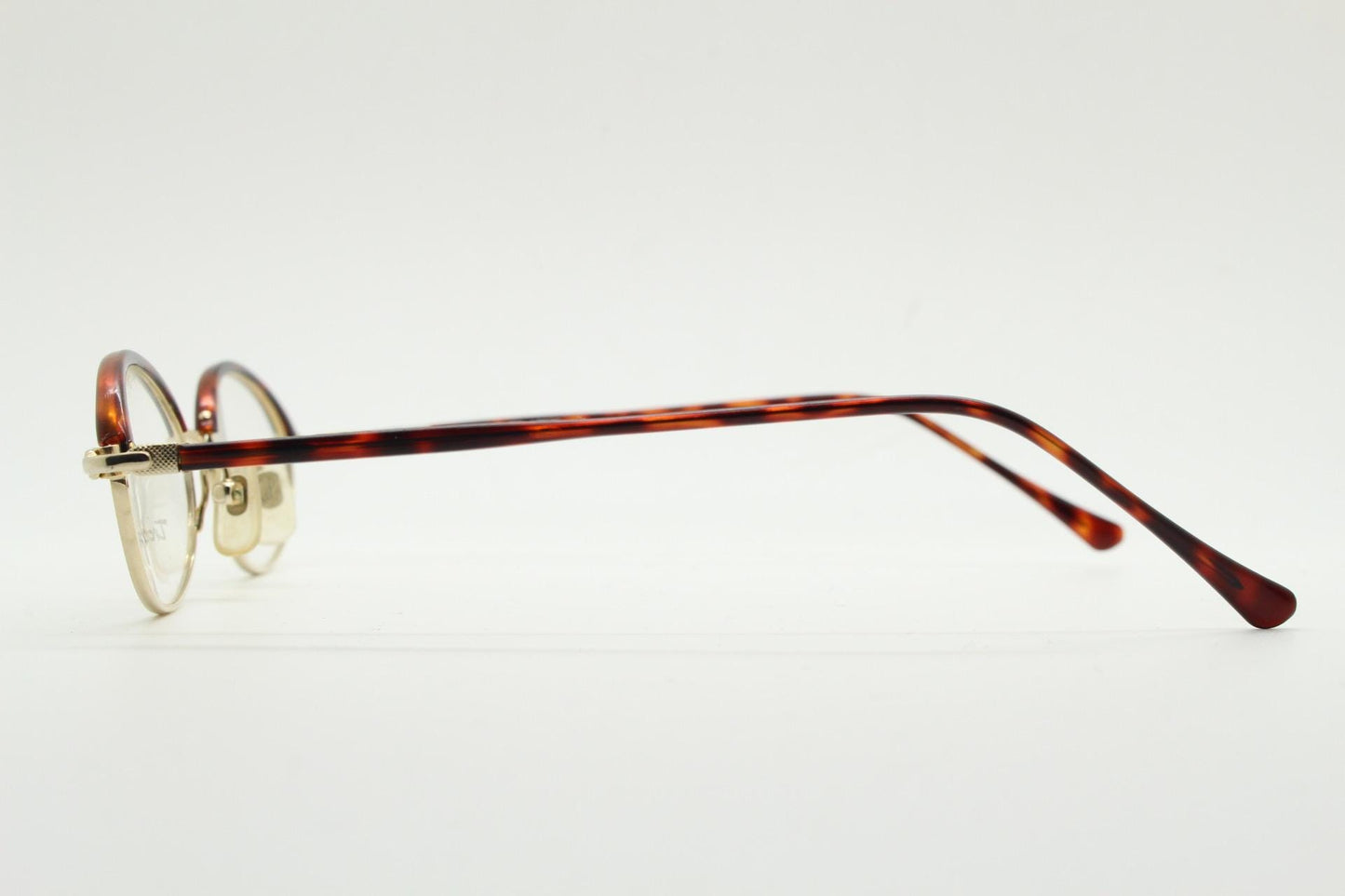 90s vintage small oval eye glasses by Tropical. Minimal gold optical frames with tortoise arms and brows. Prescription RX spectacles. NOS