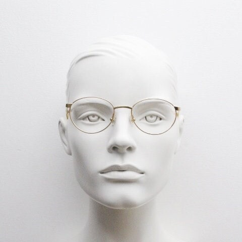 Christian Dior 90s vintage oval eye glasses made in Austria. Lustrous gold finish optical frame with CD chain link arms. Prescription RX NOS
