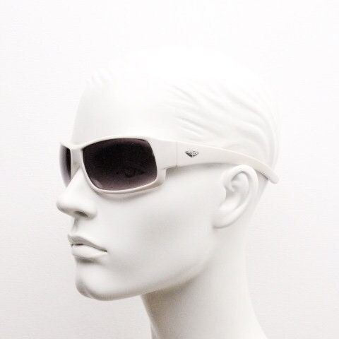 Uvex Y2k vintage wrap around bug eye sunglasses. Curving white sports shield frame with black lenses and tartan interior. Rave 2000s. NOS