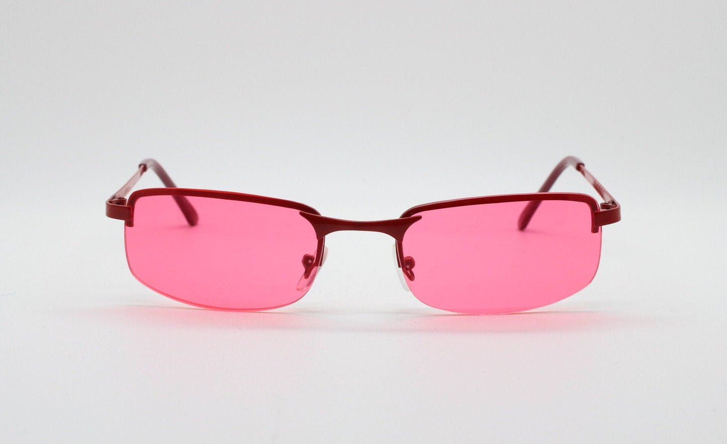 Y2K vintage half frame sunglasses with rectangular pink lenses and matching frame colours. 2000s NOS. 00's. 90s Rave