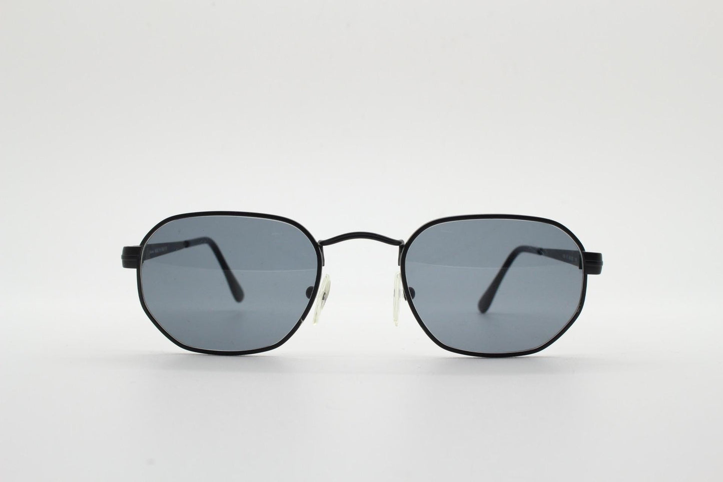 Prestige 90s vintage small oval sunglasses model 119 made in Italy. Black matt metal frame with with subtle angular facets, NOS octagon