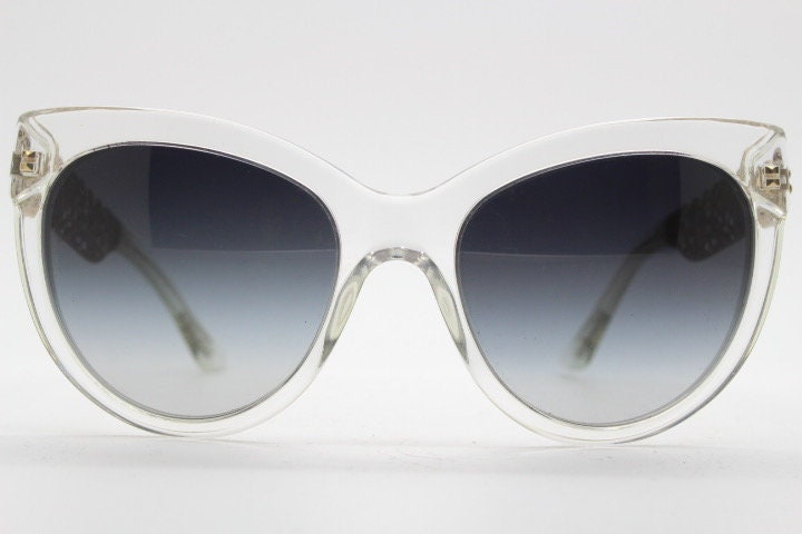 Dolce and Gabbana oversized cateye sunglasses model 4211. Womens transparent cat eye with cut-out florid metal arms and smoky lenses. NOS