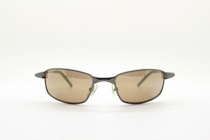 90s vintage curved rectangular sunglasses. Solid metal low profile frame in brown chrome with slightly mirrored lenses. 2000's. Y2K NOS