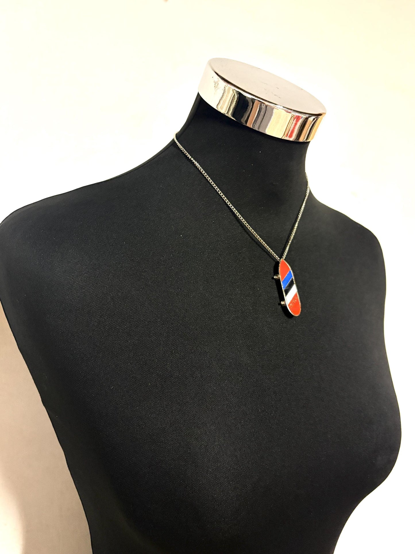 80s vintage skateboard pendant necklace. Metal chrome with enamelled red, blue and white colour stripes. Charming authentic design. NOS