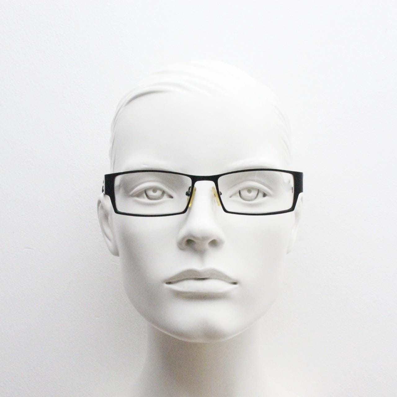 Police 90s vintage rectangular eye glasses model 023. Solid metal optical frame in black satin finish with cut out arm stripes. Prescription