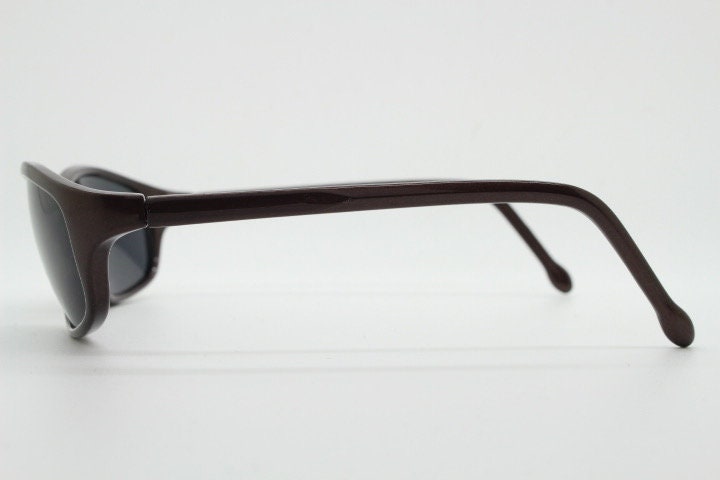 Y2K vintage wrap around shield sunglasses. Brown aerodynamic high gloss frame with black curved lenses. 2000's sport. New Old Stock 90s