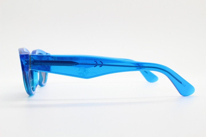 Retrosuperfuture thick cat eye sunglasses hand made in Italy. Intense blue acetate chunky frame with tasteful navy lenses. NOS