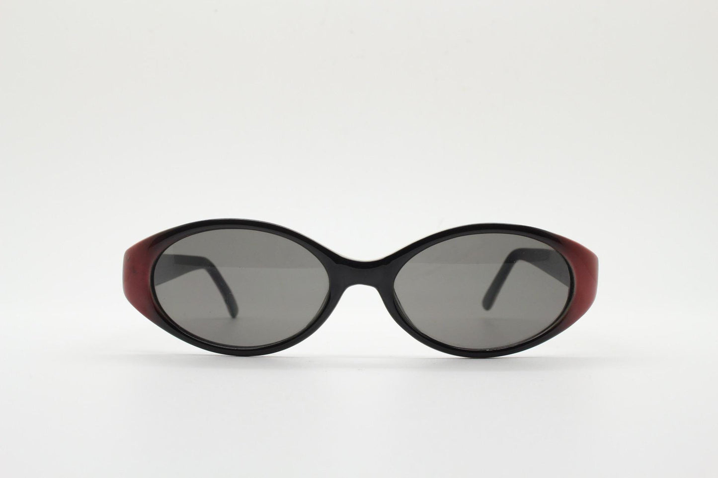 Vintage 90s oval sunglasses with very unique abstract arm pattern in black and red on layered acetate. Authentic original design. NOS