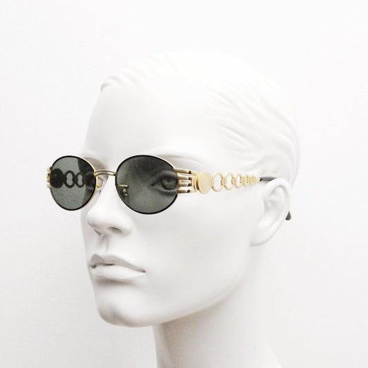 Vintage oval gold sunglasses with green lenses. Definitive 90s design including chain link circle arms and corner vents. Unused NOS