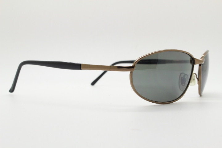 Y2K vintage small bug eye sunglasses. Curved brown chrome metal frame with black arms. Unused 2000s NOS
