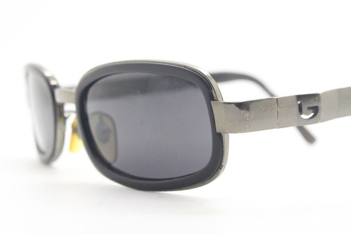 Byblos 90s vintage low profile rectangular sunglasses made in Italy. Gunmetal grey chrome frame with black insets and cut out arm logo's