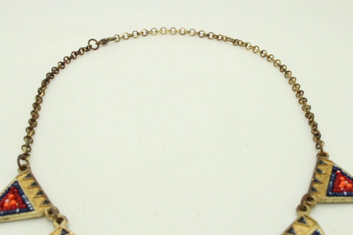 80s vintage gold triangles necklace. Aztec style with multi coloured bead inlays and ornate patterns. Womens statement design