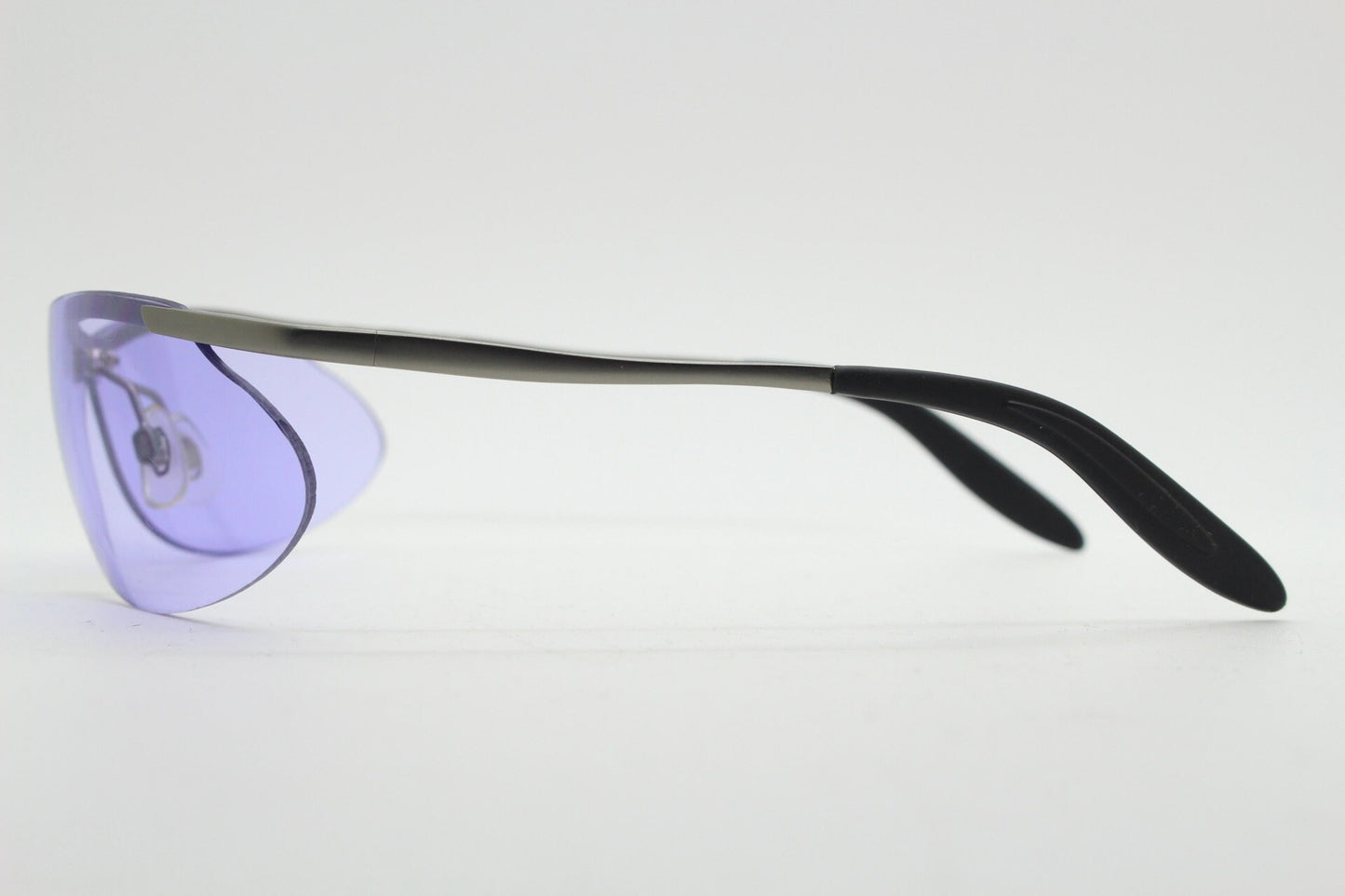 Y2K vintage sport shield sunglasses. 2000's half frame wraparound aerodynamic mini mask visor with purple bug eye lenses. 90s 00s unused NOS