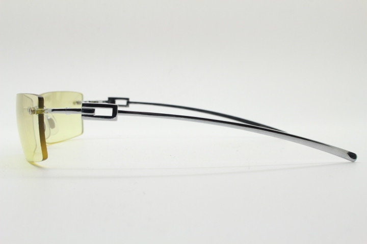 Y2K vintage rectangular sunglasses. Minimal frameless light tone curved mirrored lenses with silver chrome trim. 2000's. 90s. 00s. NOS
