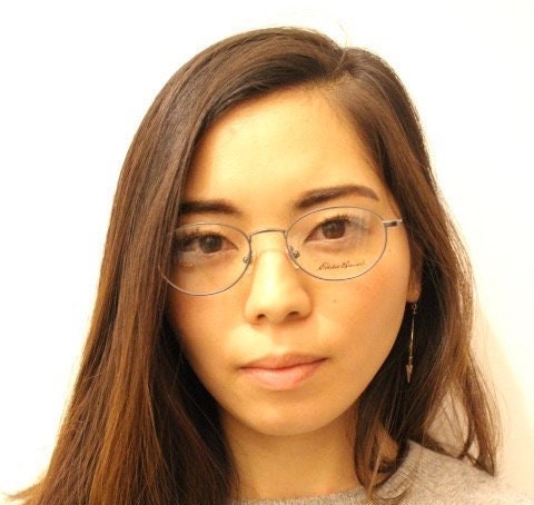 Eddie Bauer 90s vintage oval eye glasses. Minimal black matt finish optical frames with kinked arms. Stainless steel spectacles. NOS