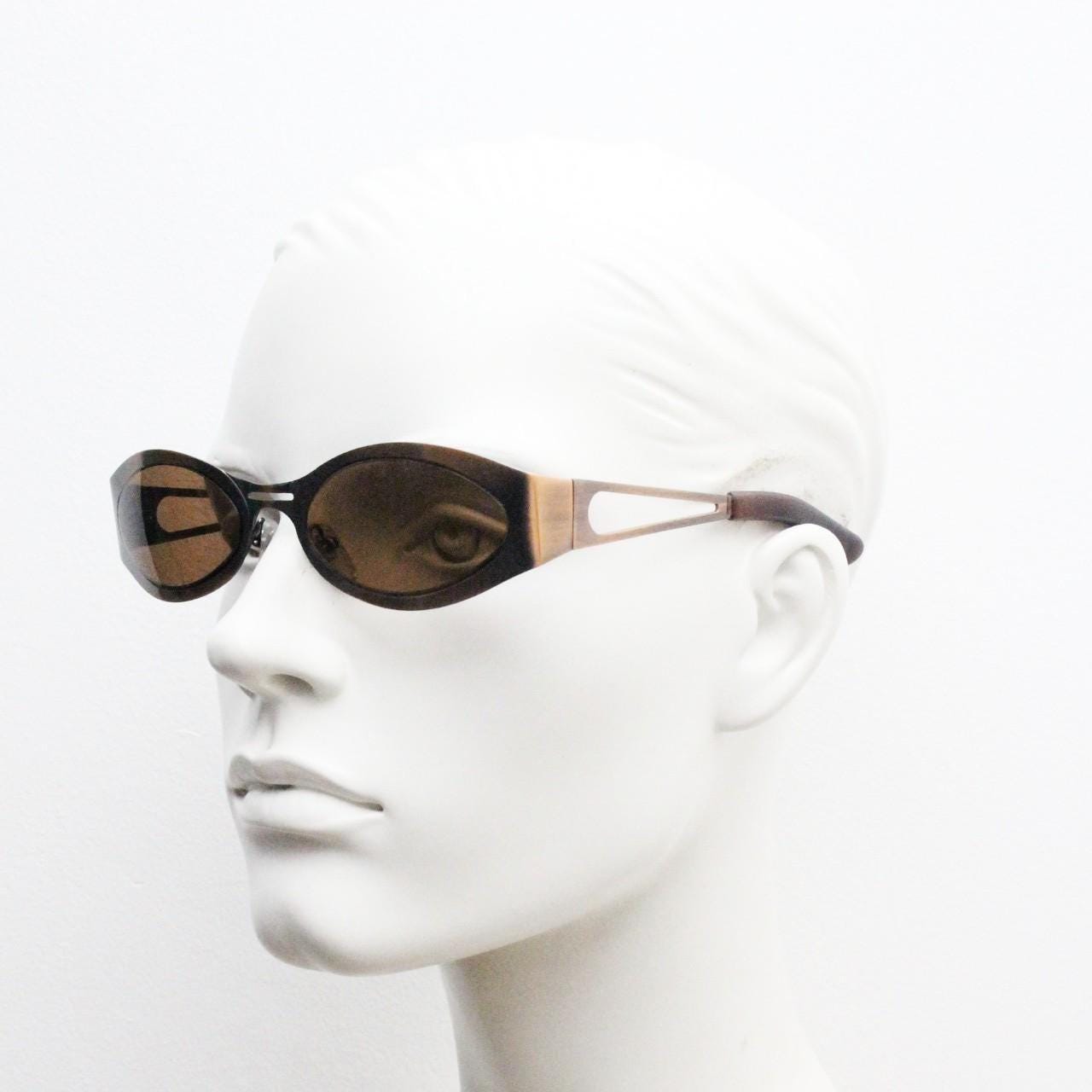 2000s vintage wraparound angular sunglasses. brushed copper finish flat curved metal frame with cut out arms. 90s. Y2K unused NOS