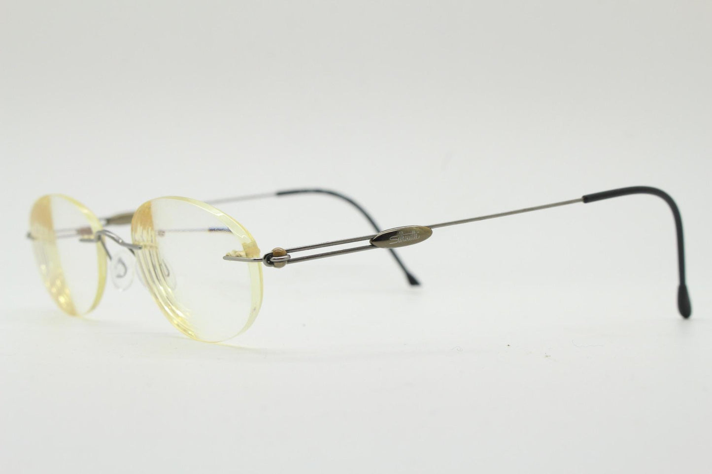 Silhouette vintage oval frameless eye glasses made in Austria. Minimal lightweight brown chrome optical frame. Prescription spectacles