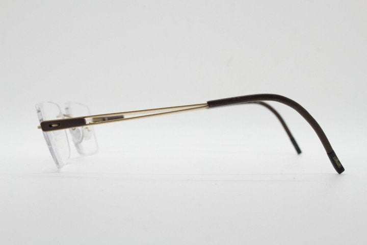 Silhouette rectangular frameless eye glasses model 7677 made in Austria. Minimal lightweight optical frame with golden trim. Prescription RX
