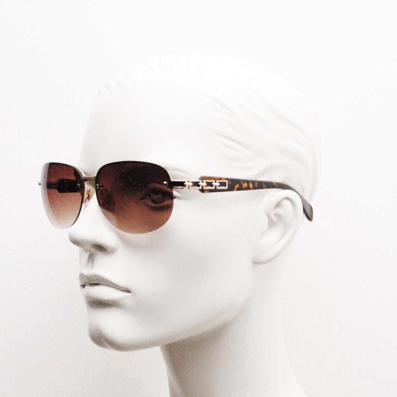 Y2K vintage rectangular brown sunglasses. Gold half frame with tortoise arms, chain link temples and graduating lenses. 2000's NOS