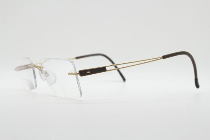 Silhouette rectangular frameless eye glasses model 7677 made in Austria. Minimal lightweight optical frame with golden trim. Prescription RX