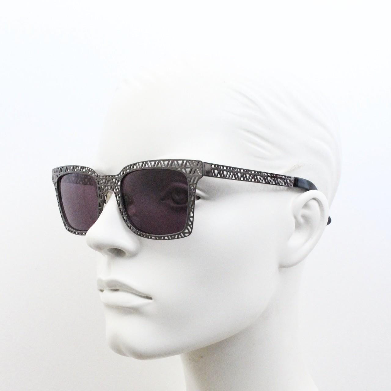 Sass and bide vintage wayfarer shape sunglasses. Gunmetal grey flat metal frame with cut out patterns throughout and black lenses. 2000s NOS