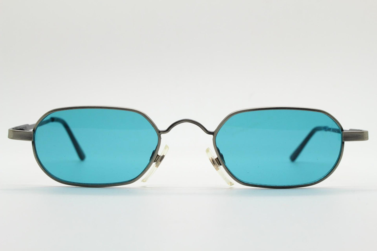 90s vintage small angular oval sunglasses by Blue Point. Low profile brushed bronze finish metal frame with turquoise blue lenses, NOS