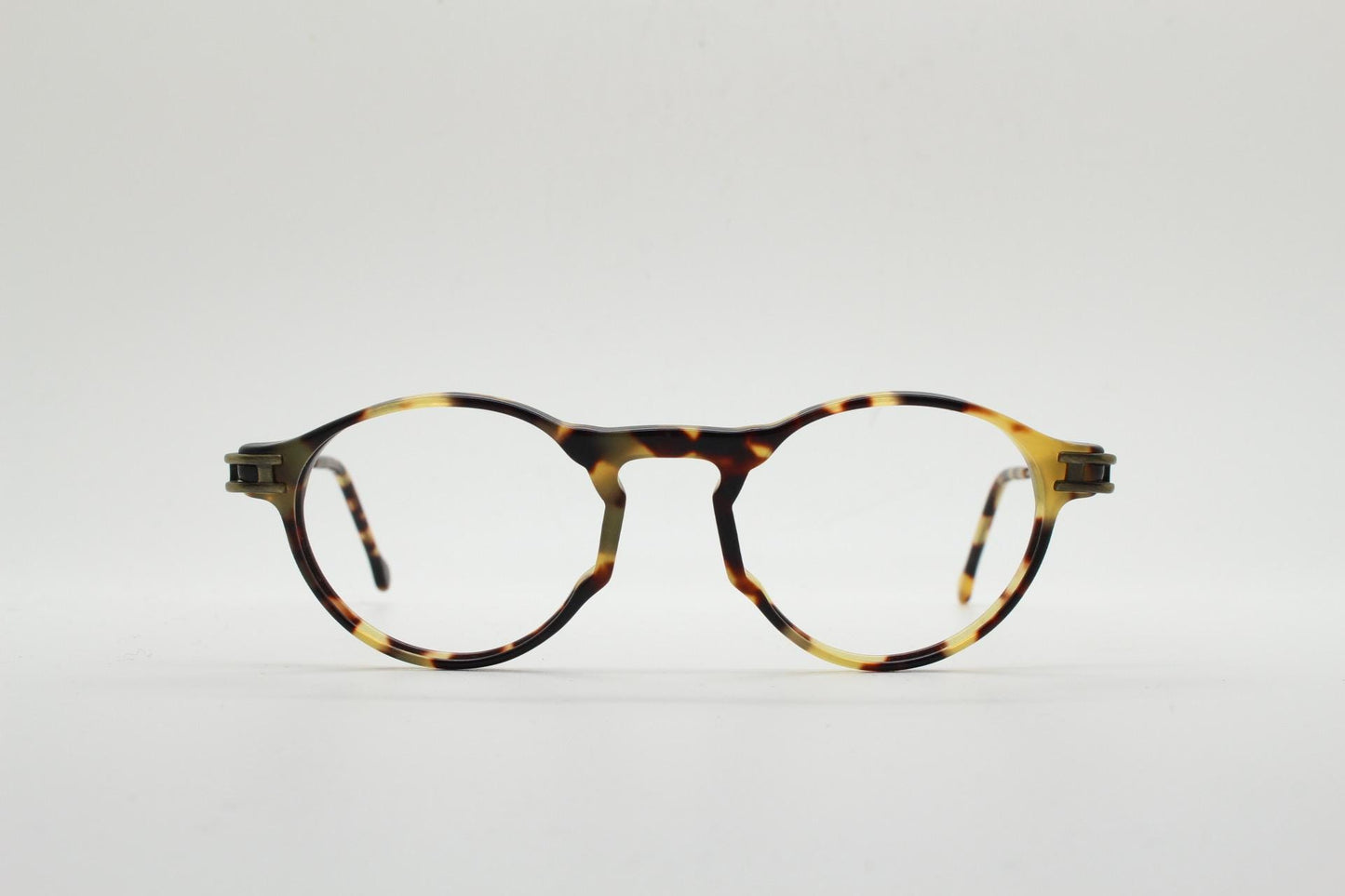 90s vintage oval eye glasses by No Limits. Honey tortoise optical frames with dynamic zig zag arms. Prescription RX spectacles. NOS