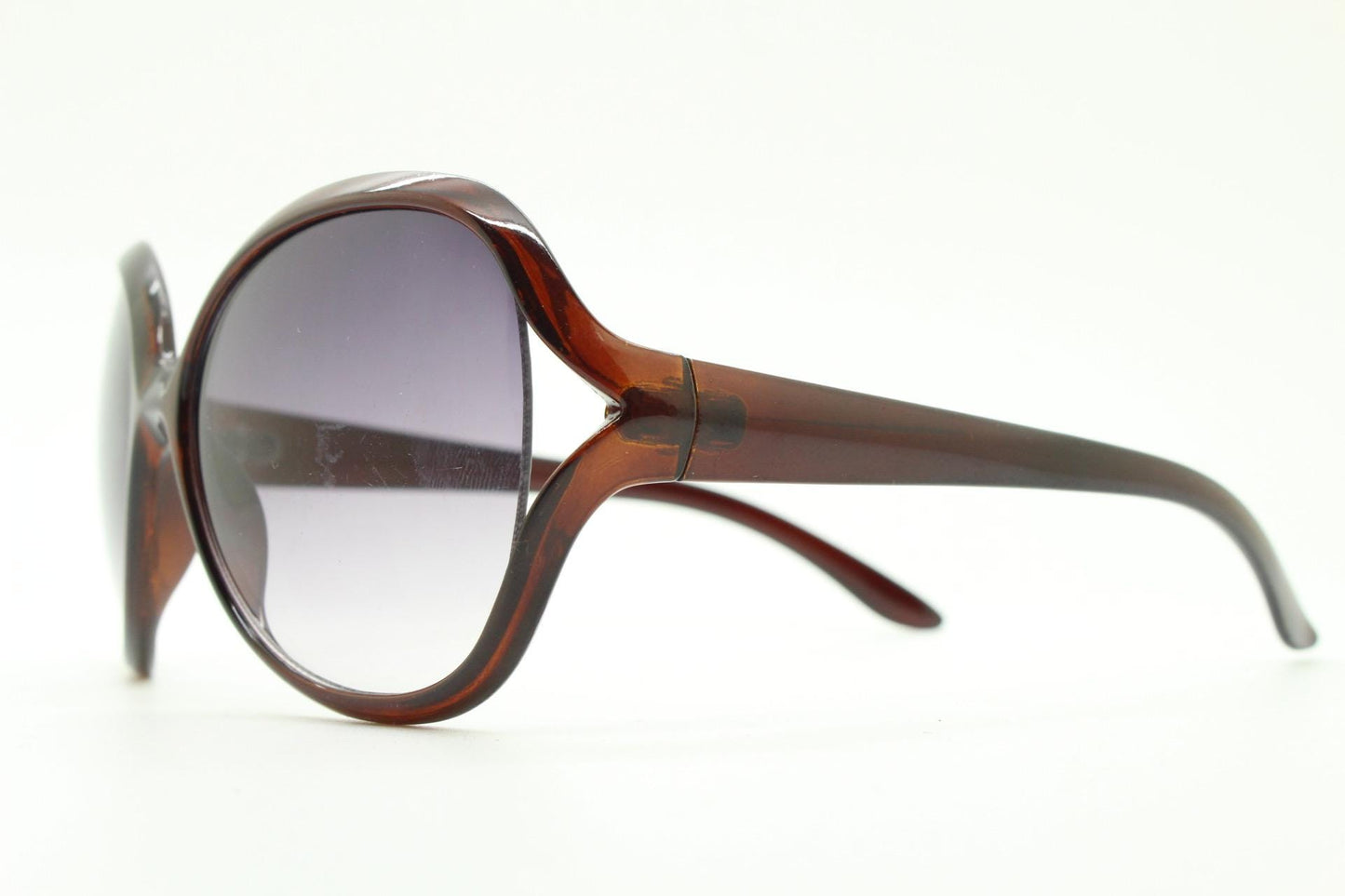 Y2K vintage big round angular sunglasses. Women's 70s design in transparent brown with graduating lenses and forked side detail. 2000s NOS